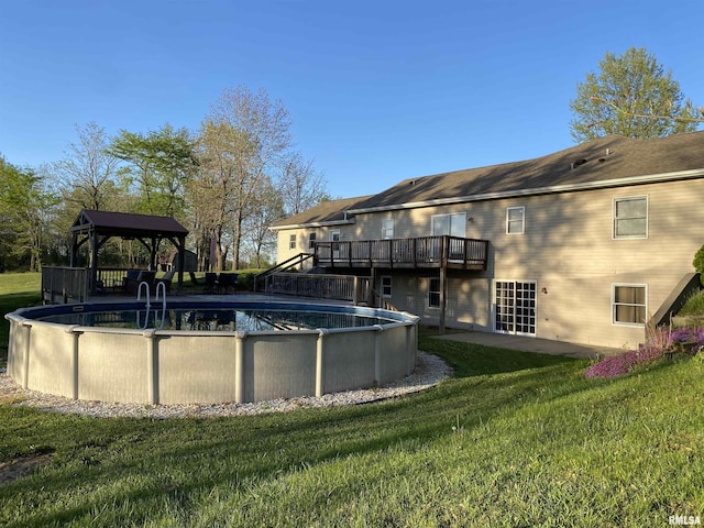 outdoor pool featuring a yard, a gazebo, and a deck