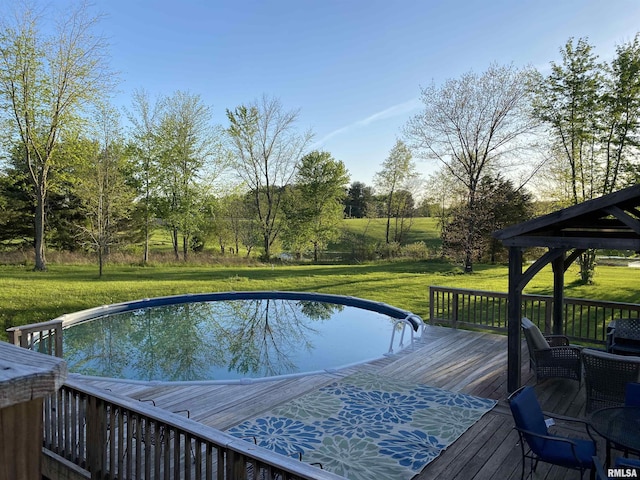 pool with a wooden deck, a gazebo, a yard, and outdoor dining space
