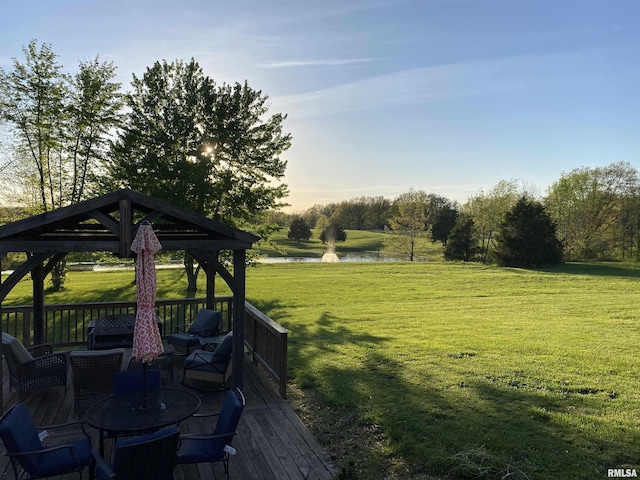 wooden terrace with a lawn, a gazebo, and a water view