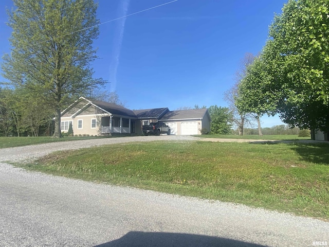 ranch-style house featuring an attached garage, dirt driveway, and a front lawn