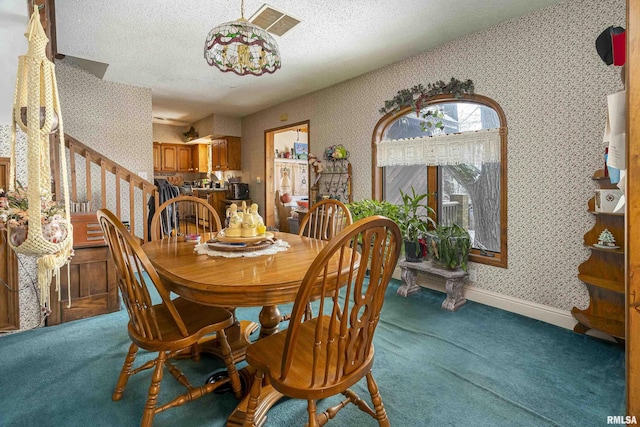 dining space featuring wallpapered walls, stairway, a textured ceiling, and carpet flooring