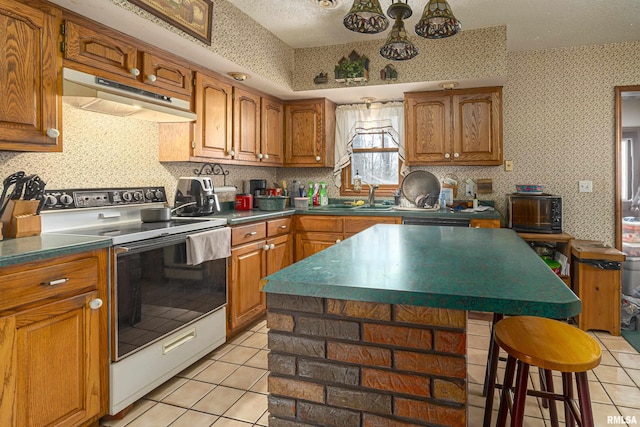 kitchen with wallpapered walls, under cabinet range hood, range with electric cooktop, and light tile patterned flooring
