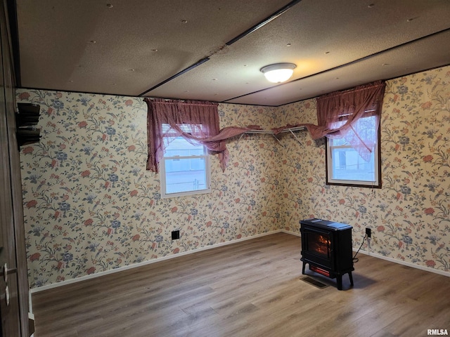 14625 E E Il Highway 15, Mount Vernon, IL 62864 - spare room featuring plenty of natural light, wood finished floors, and a wood stove