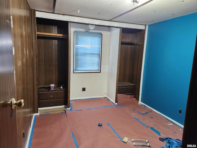 14625 E E Il Highway 15, Mount Vernon, IL 62864 - unfurnished bedroom with wooden walls, a closet, and baseboards