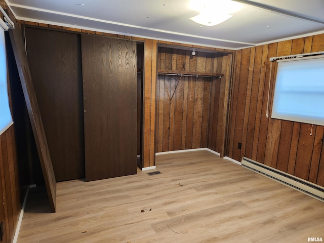 14625 E E Il Highway 15, Mount Vernon, IL 62864 - unfurnished bedroom with light wood-type flooring, wooden walls, visible vents, and a baseboard heating unit