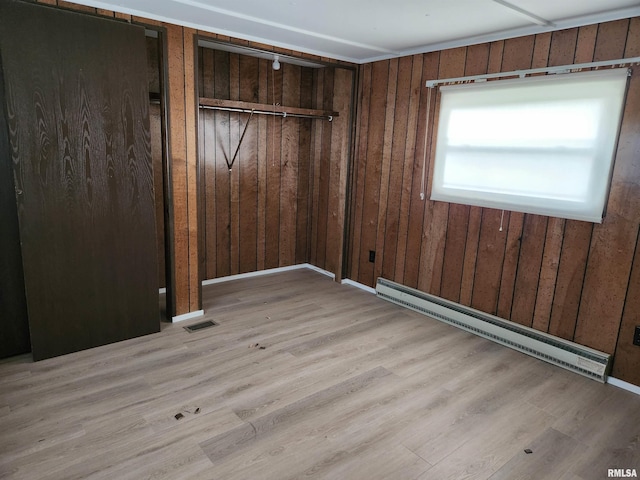 14625 E E Il Highway 15, Mount Vernon, IL 62864 - unfurnished bedroom featuring a baseboard radiator, wood walls, wood finished floors, and visible vents