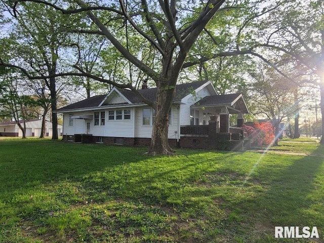 view of side of home featuring a lawn and a chimney