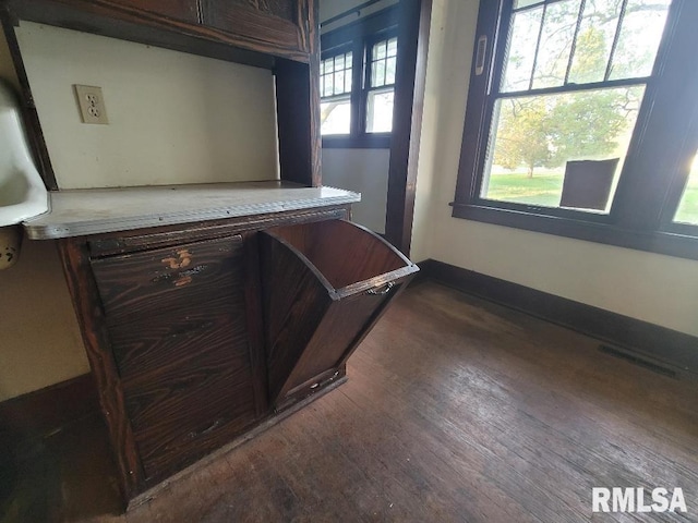 interior details featuring wood finished floors, visible vents, and baseboards