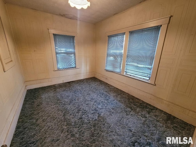 carpeted empty room with baseboards