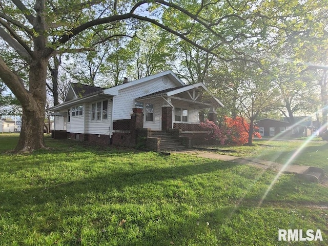 view of front of home featuring covered porch and a front yard