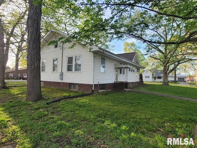 view of property exterior featuring a lawn