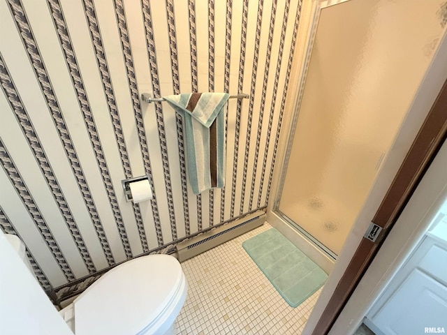 bathroom featuring a baseboard radiator, a stall shower, wallpapered walls, toilet, and tile patterned floors