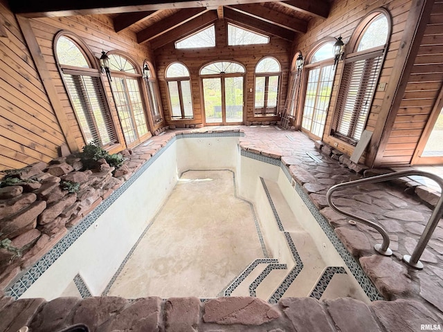 interior space with beam ceiling and french doors