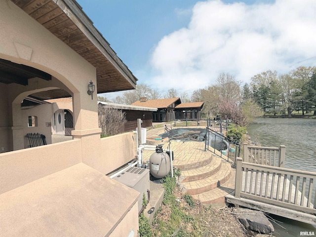 view of yard with a water view and a patio area