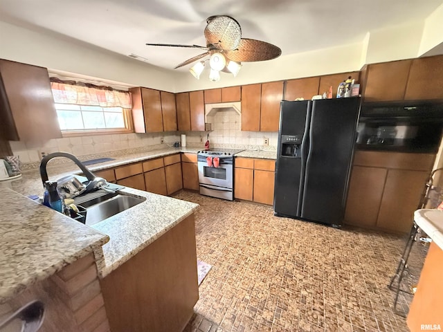 kitchen with brown cabinets, black fridge with ice dispenser, a sink, stainless steel electric stove, and a ceiling fan