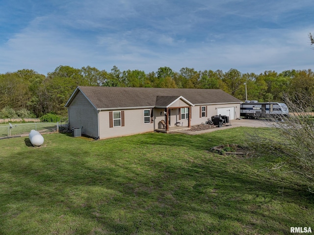 ranch-style house featuring a front lawn, driveway, a garage, and fence
