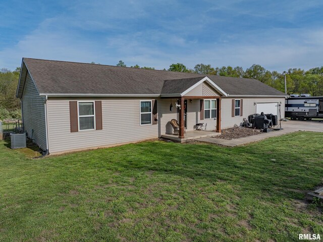 ranch-style house with a front lawn, concrete driveway, an attached garage, and covered porch