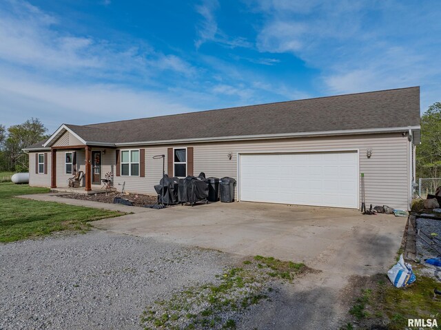 ranch-style home with driveway and an attached garage