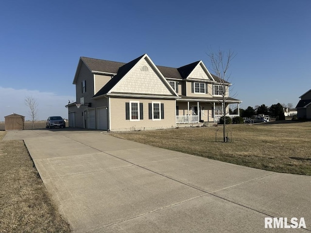 view of front of home with a garage, a porch, a front lawn, and driveway