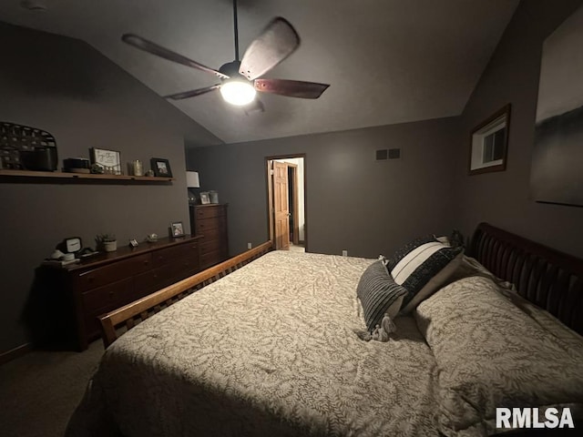 bedroom with carpet flooring, a ceiling fan, visible vents, and vaulted ceiling