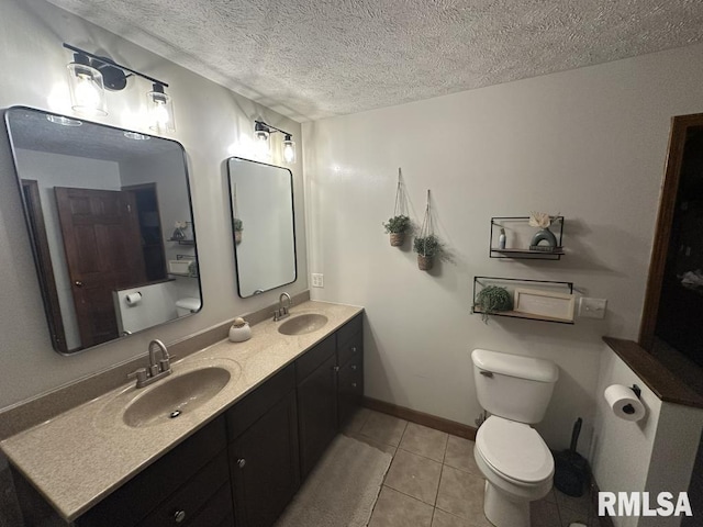 full bath with tile patterned floors, toilet, double vanity, and a sink