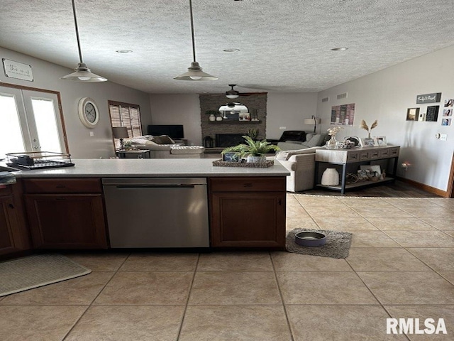 kitchen with light tile patterned floors, dishwasher, open floor plan, and pendant lighting
