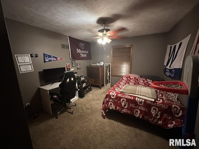 carpeted bedroom featuring a textured ceiling, visible vents, and ceiling fan