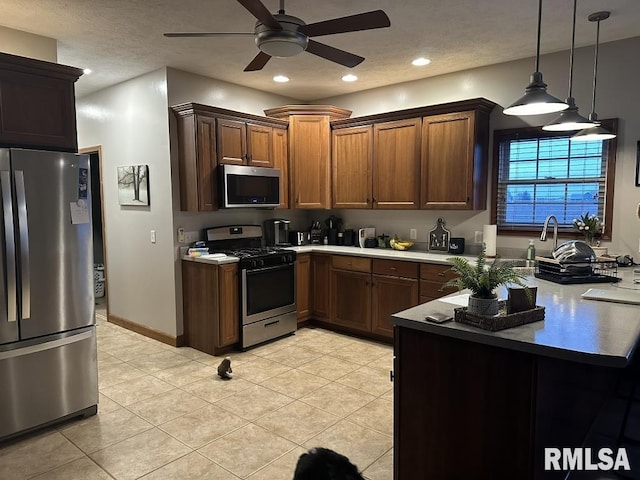 kitchen with recessed lighting, stainless steel appliances, light tile patterned flooring, a ceiling fan, and pendant lighting