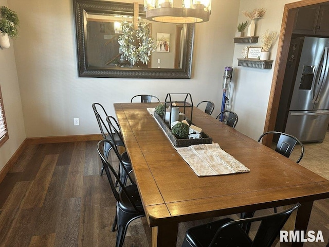 dining space featuring baseboards and wood finished floors