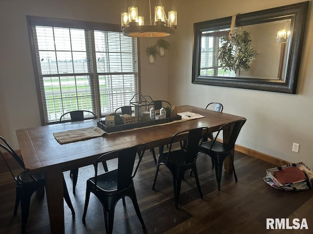 dining space with baseboards, wood finished floors, a notable chandelier, and plenty of natural light
