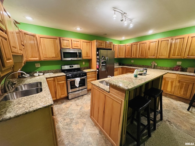 501 N Marion St, Salem, IL 62881 - kitchen with light stone countertops, an island with sink, a breakfast bar area, appliances with stainless steel finishes, and a sink