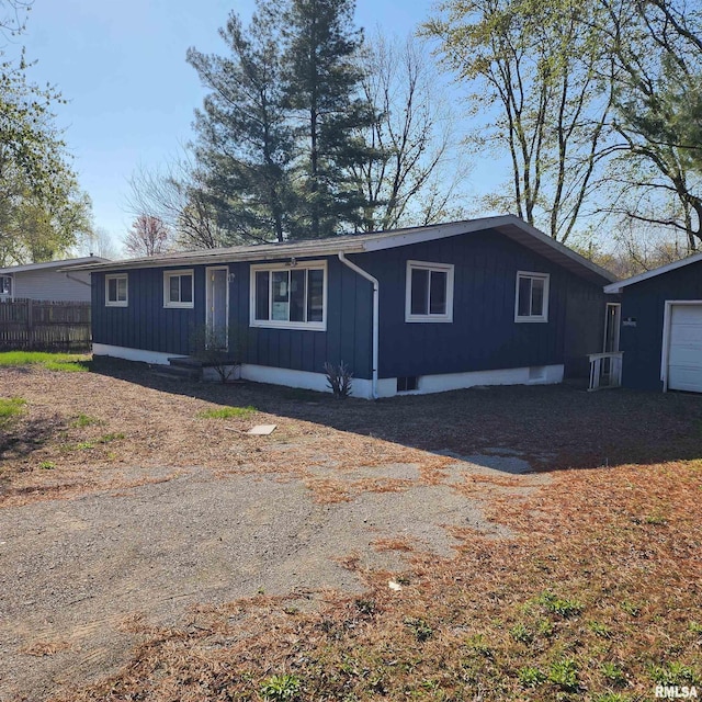 view of front of house with fence and board and batten siding
