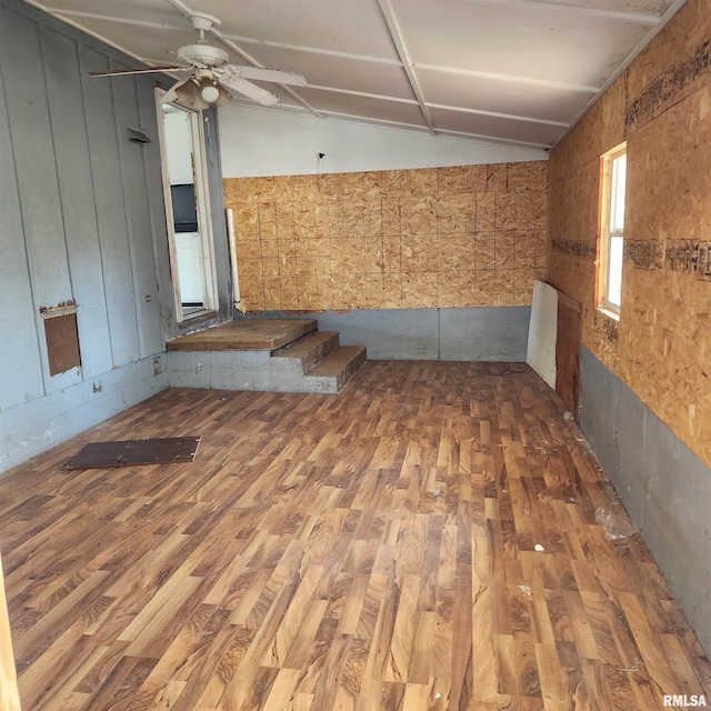 unfurnished room featuring lofted ceiling, wood finished floors, and ceiling fan