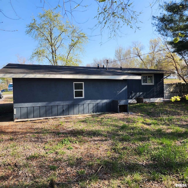 rear view of house with fence