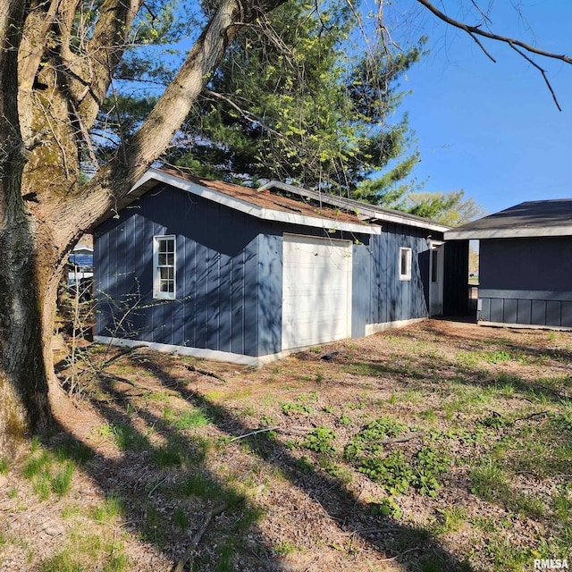 view of outdoor structure featuring a garage and an outbuilding