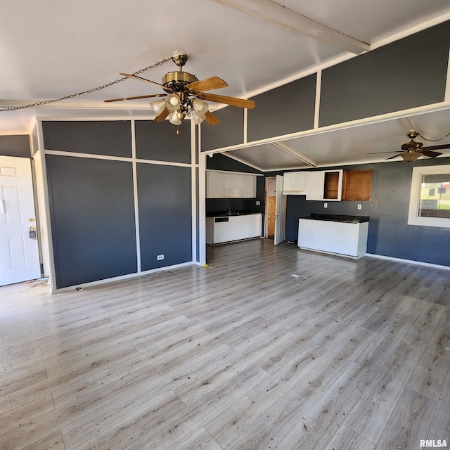 unfurnished living room featuring baseboards, wood finished floors, a ceiling fan, and lofted ceiling