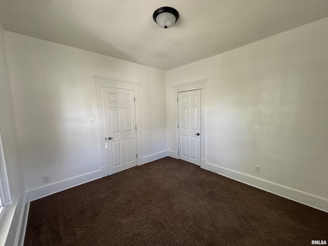 1014 E Broadway St, Centralia, IL 62801 - spare room featuring baseboards and dark colored carpet