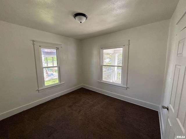 1014 E Broadway St, Centralia, IL 62801 - unfurnished room with baseboards and dark colored carpet