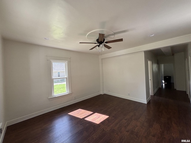 1014 E Broadway St, Centralia, IL 62801 - empty room featuring ceiling fan, dark wood-style floors, and baseboards