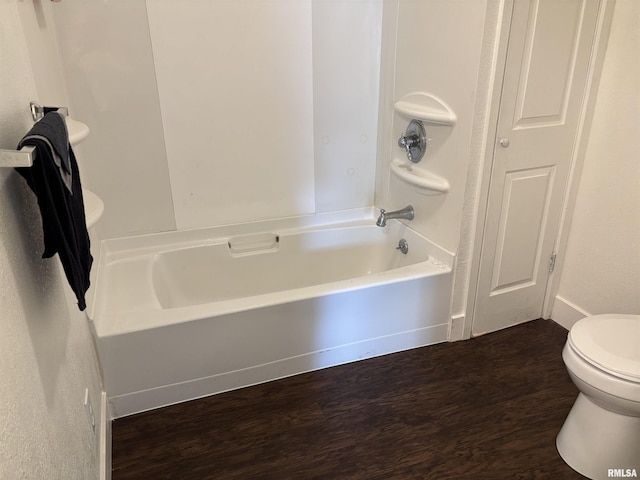 1014 E Broadway St, Centralia, IL 62801 - bathroom with wood finished floors, toilet, and tub / shower combination