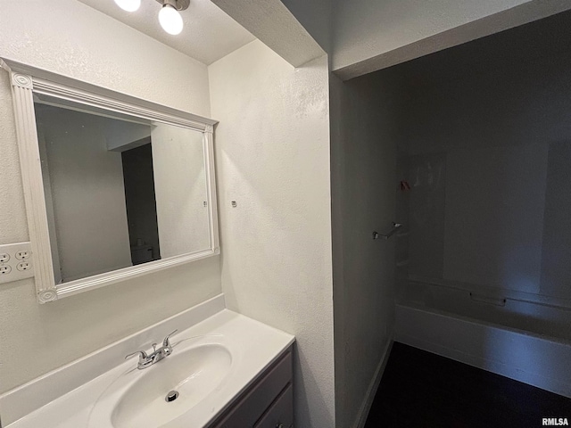 1014 E Broadway St, Centralia, IL 62801 - full bathroom with vanity, a textured wall, and a shower