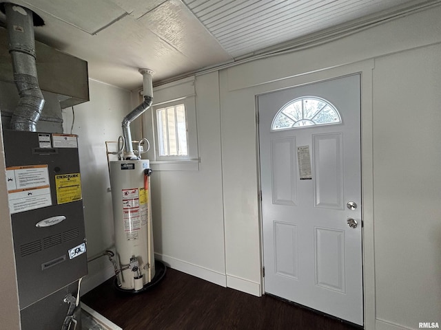 1014 E Broadway St, Centralia, IL 62801 - foyer entrance with gas water heater, plenty of natural light, dark wood-style flooring, and baseboards