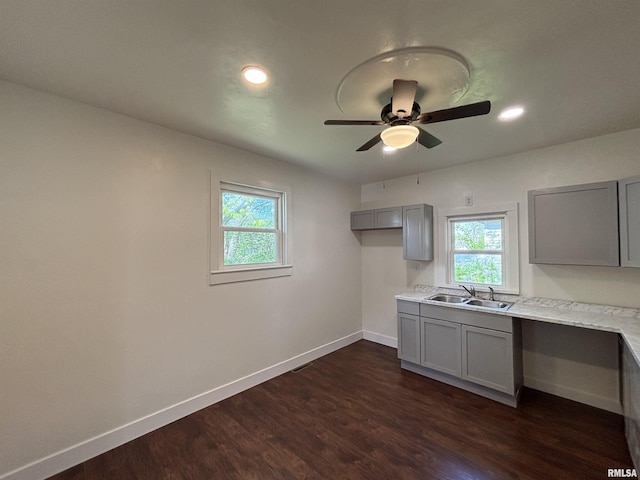 1014 E Broadway St, Centralia, IL 62801 - kitchen featuring gray cabinets, a sink, baseboards, ceiling fan, and plenty of natural light
