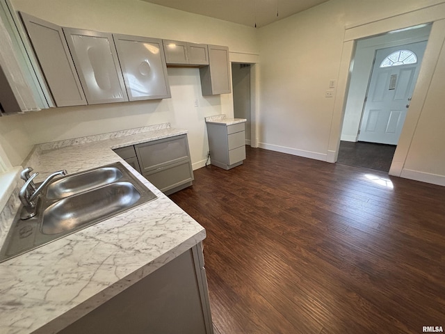 1014 E Broadway St, Centralia, IL 62801 - kitchen featuring gray cabinets, a sink, dark wood-style flooring, and baseboards