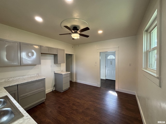 1014 E Broadway St, Centralia, IL 62801 - kitchen with gray cabinets, dark wood-type flooring, ceiling fan, a sink, and baseboards
