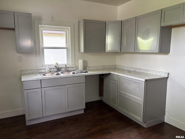 1014 E Broadway St, Centralia, IL 62801 - kitchen with gray cabinets, a sink, dark wood-style floors, and baseboards