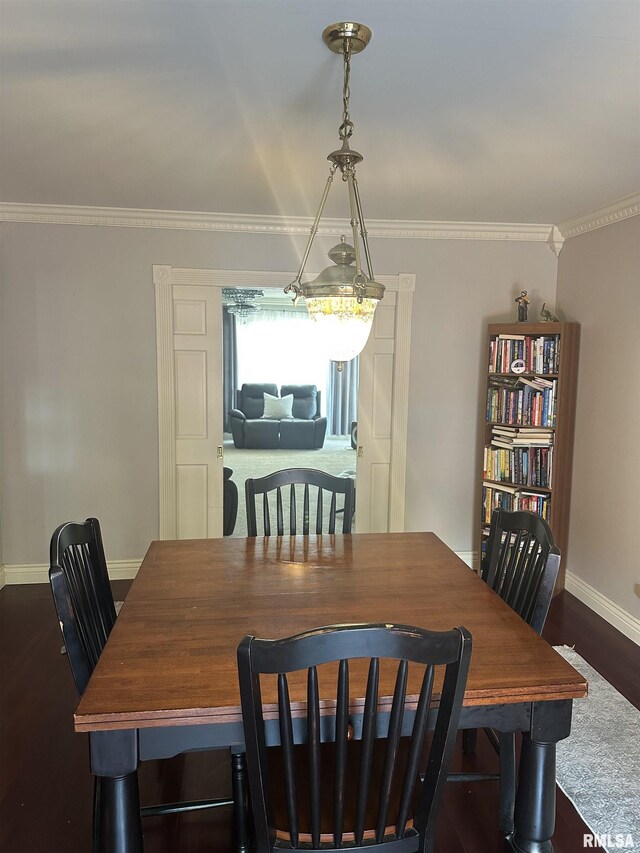 dining room with baseboards, dark wood-style flooring, and crown molding