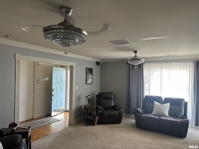 carpeted living room with crown molding and baseboards