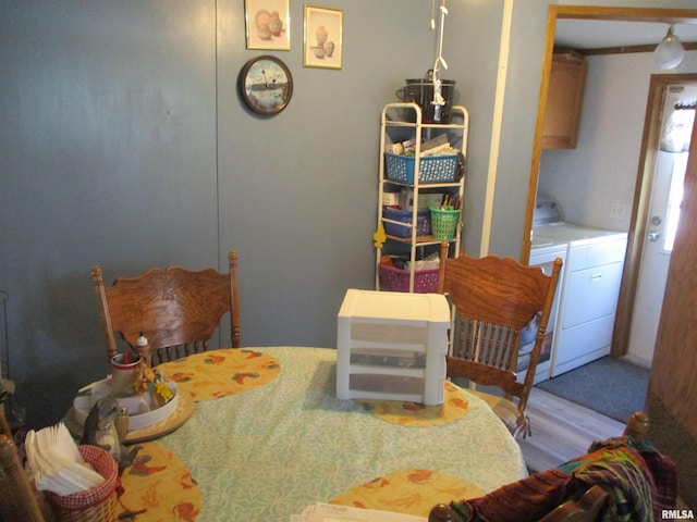 bedroom featuring wood finished floors and washer and clothes dryer