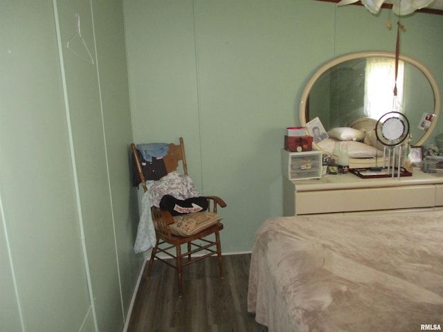 bedroom with dark wood-style flooring